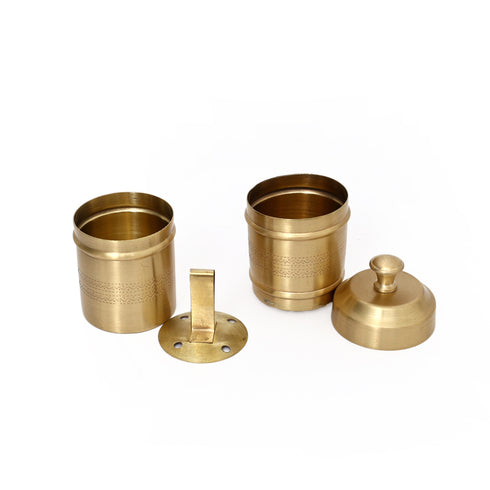 Set of brass containers and accessories on a white background