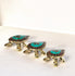 A set of three brass tortoise figurines with turquoise and red detailing on their shells, displayed against a neutral background.
