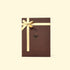 Brown gift box with a gold ribbon on a beige background