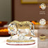 Decorative elephant figurine with intricate detailing on a blurred background