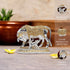 Decorative elephant statue with gold and silver finish on a wooden surface.