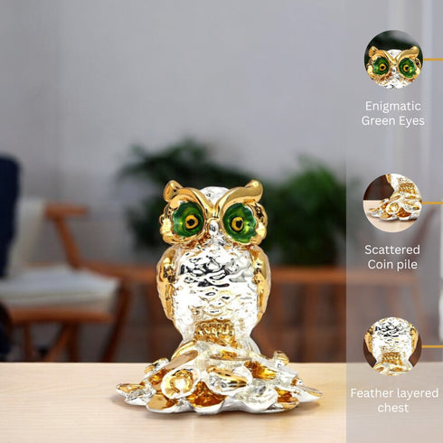 Decorative owl figurine with gold and silver finish on a blurred indoor background