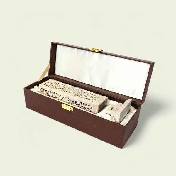 Decorative stone object in a wooden box on a light beige background