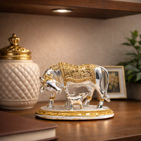 Decorative sculpture of a bull and calf on a wooden surface with a blurred background