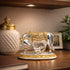 Decorative sculpture of a bull and calf on a wooden surface with a blurred background