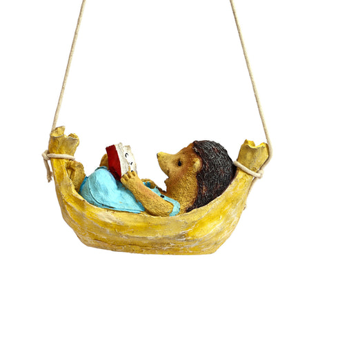 Hanging Hedgehog reader on a swing