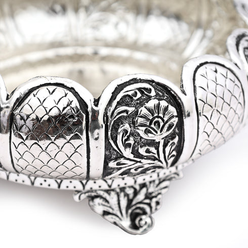 Silver bracelet with intricate designs on a white background