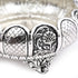 Silver bracelet with intricate designs on a white background