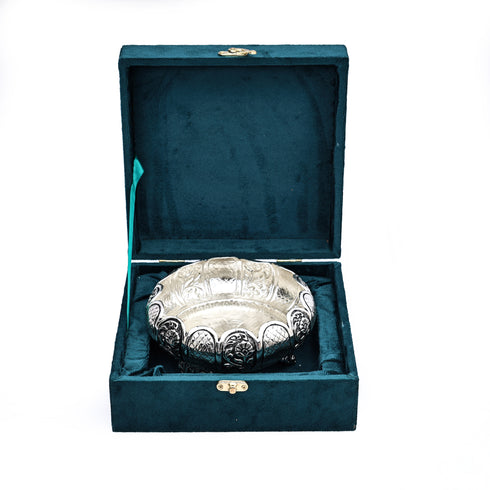 Decorative silver bowl in a teal box on a white background