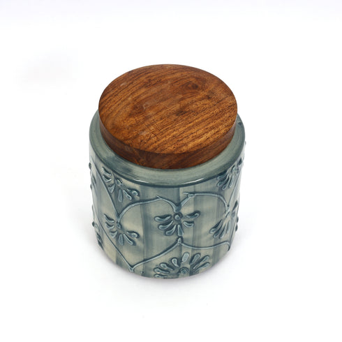 Ceramic jar with wooden lid on a white background