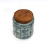 Ceramic jar with wooden lid on a white background