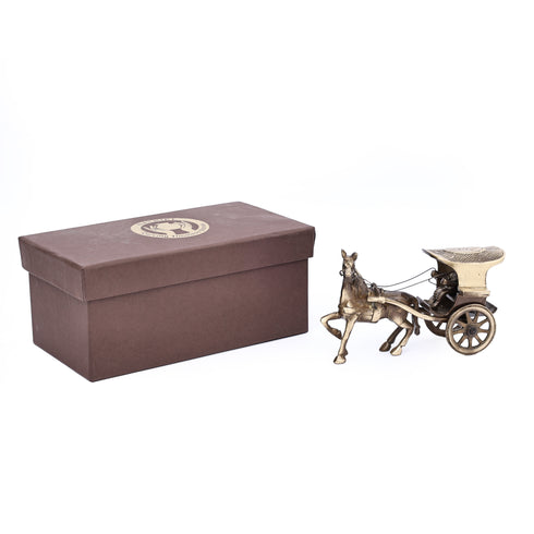 Bronze horse-drawn carriage next to a brown box on a white background