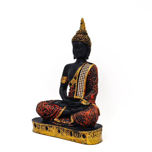 Decorative statue of a seated figure with black, gold, and red colors on a white background