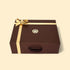 Brown gift box with gold ribbon and logo on a beige background