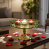 Decorative candle holder with floating candles on a table in a living room setting.