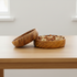 Wooden bowl with nuts on a wooden surface