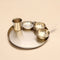 Set of metallic bowls and a cup on a beige background