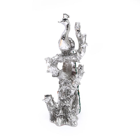 Silver-plated Peacock sitting on the branch