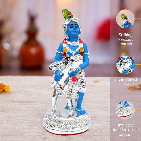 Statue of a blue-featured deity holding a cow on a textured surface with decorative elements.