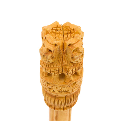 Close-up of four lions and Ashoka Chakra carved into wooden Ashoka Stambh showpiece