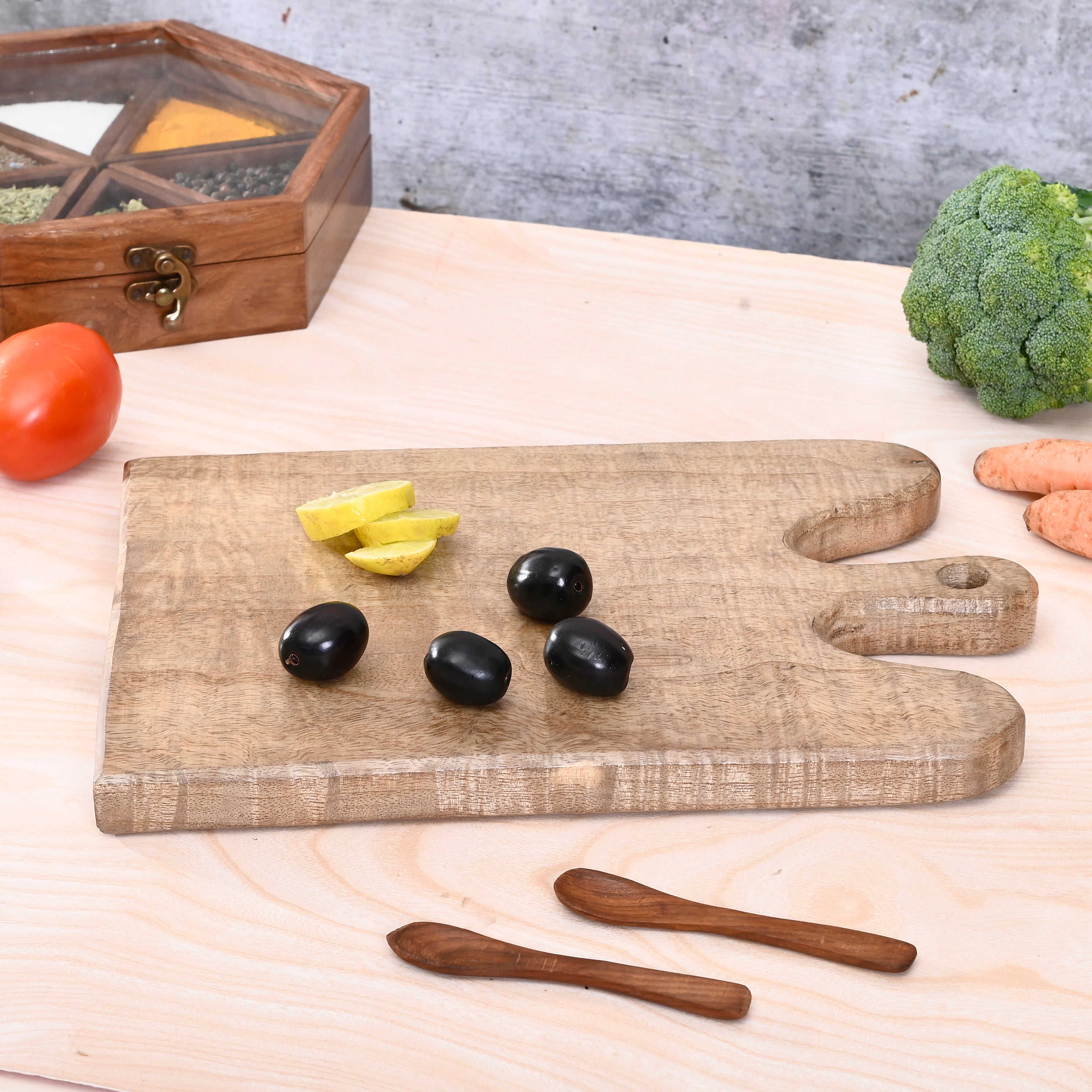 Wooden cutting board with sliced vegetables on a wooden table