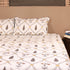 Handcrafted Leaf and Bloom Cotton King Size Bedding Set styled on a bed, showcasing coordinated bedsheet, pillow covers, and dohar.