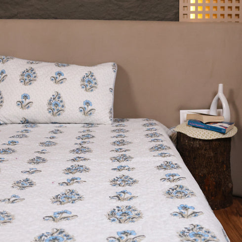 Misty Blue Floral Pattern Bedcover and Pillow Cover styled on a double bed, showcasing timeless floral designs and premium craftsmanship.
