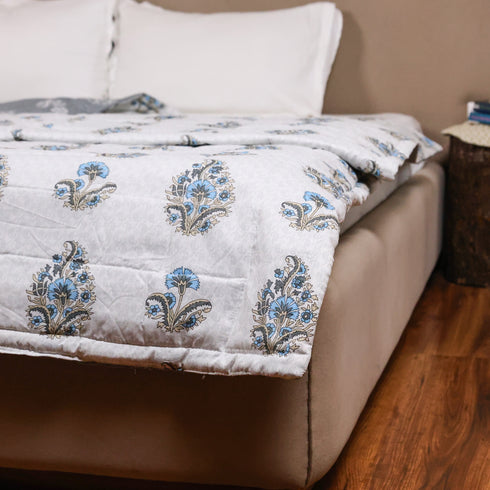 Misty Blue Floral Pattern Comforter styled on a double bed, showcasing sophisticated floral designs and luxurious comfort.