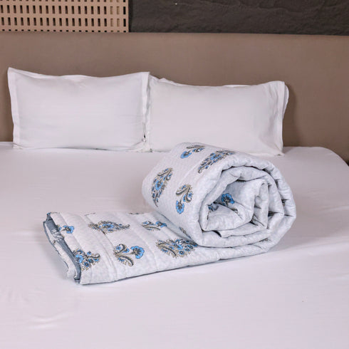 Folded Misty Blue Floral Pattern Comforter highlighting premium quilting, soft filling, and detailed floral artwork.