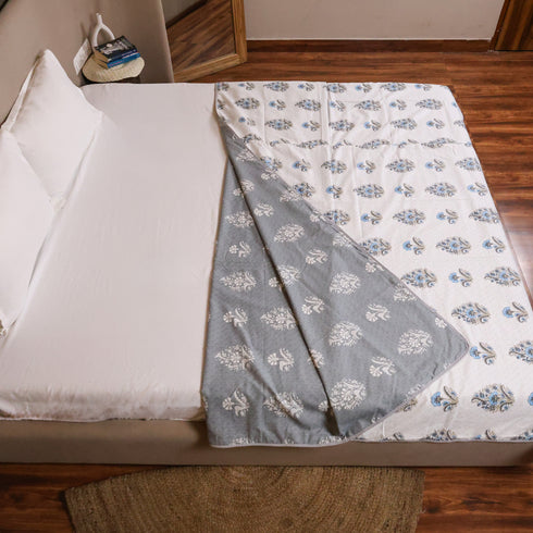 Folded Misty Blue Floral Pattern Dohar highlighting premium cotton fabric and intricate floral designs.