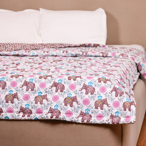 Royal Elephant Bloom Comforter styled on a double bed, showcasing heritage-inspired elephant artwork and luxurious comfort.