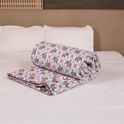 Folded Royal Elephant Bloom Double Bed Comforter highlighting premium quilting, soft filling, and intricate elephant floral prints.