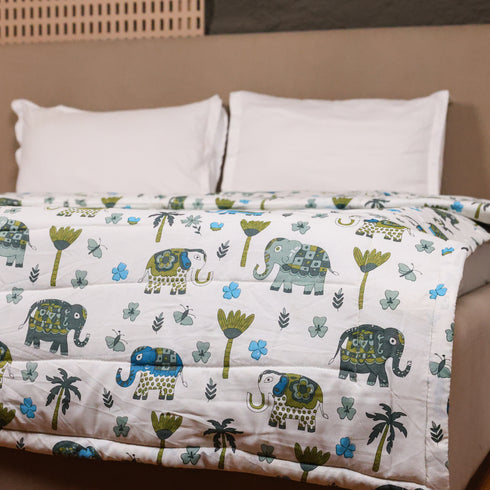 Close-up of Traditional Elephant Folk Print Comforter showcasing intricate elephant motifs, quilted stitching, and premium cotton texture.