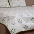 Vintage Olive Green Floral Bedcover and Pillow Cover styled on a double bed, showcasing timeless floral designs and premium craftsmanship.