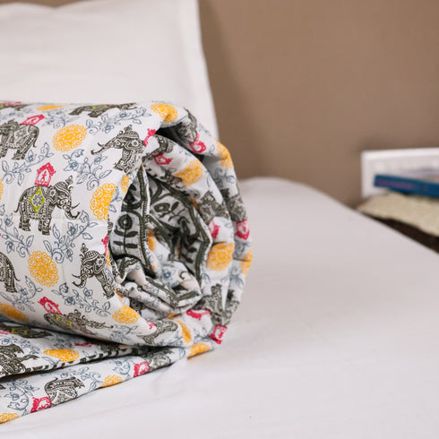 Close-up of Yellow Blossom Handcrafted Elephant Comforter highlighting quilted stitching, premium cotton fabric, and detailed handcrafted motifs.