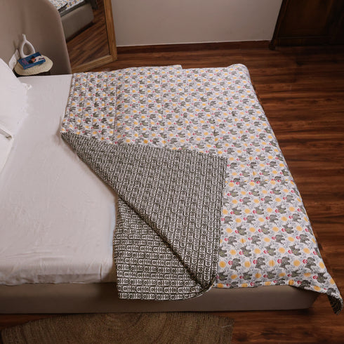 Folded Yellow Blossom Handcrafted Elephant Comforter displaying premium quilting, soft filling, and intricate elephant print details.