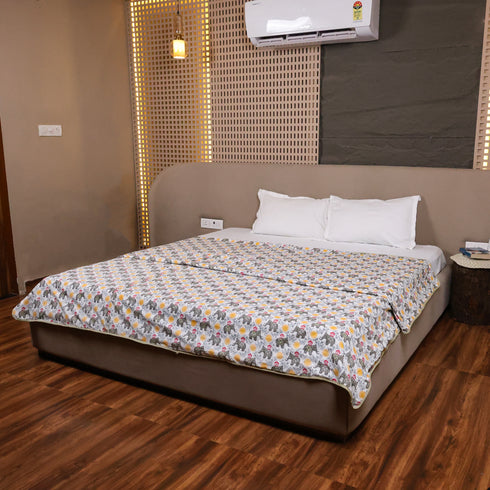 Yellow Blossom Handcrafted Elephant Dohar styled in a modern bedroom, adding comfort and elegance to the bedding.