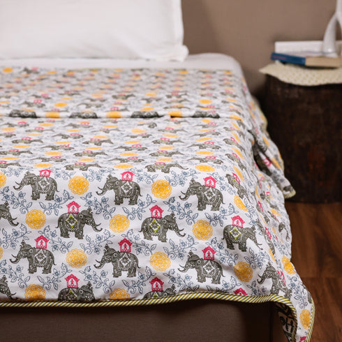Folded Yellow Blossom Elephant Dohar showcasing handcrafted cotton fabric and intricate elephant motifs.