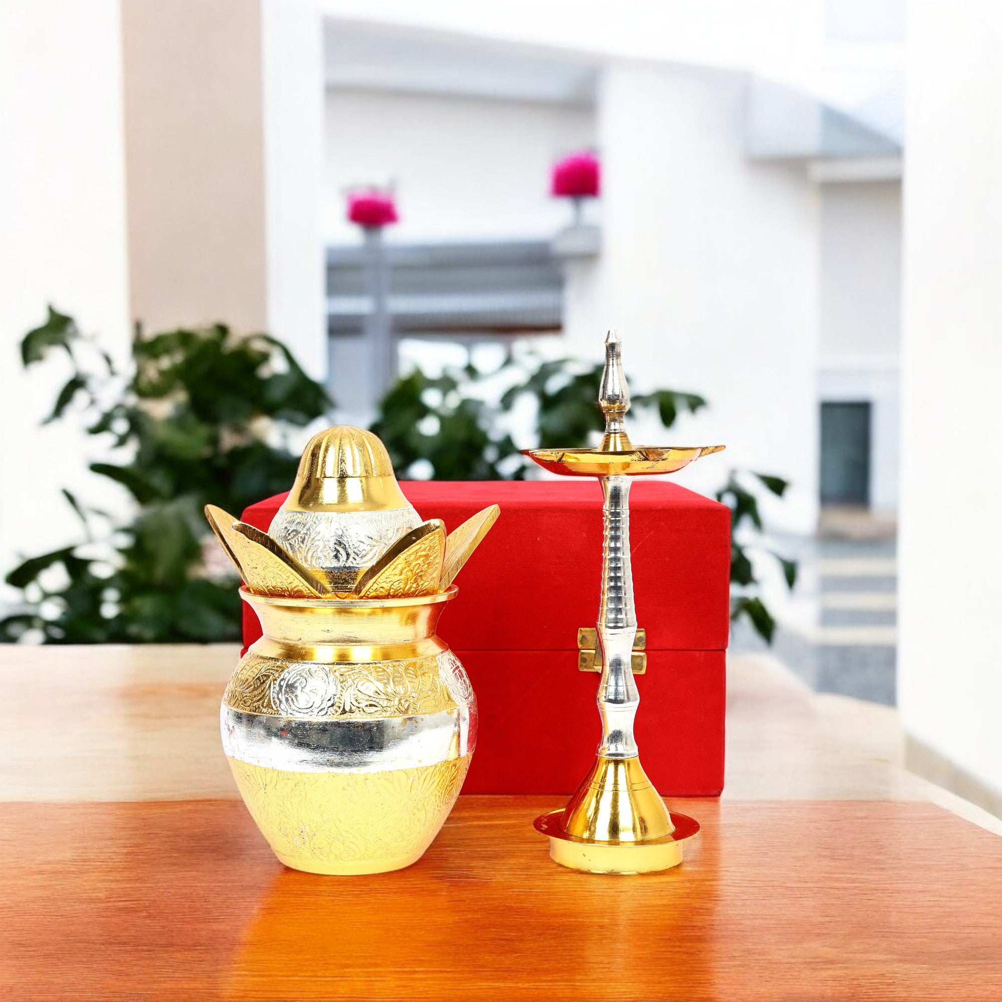 Gold and silver hookah set on a wooden table with a blurred indoor background