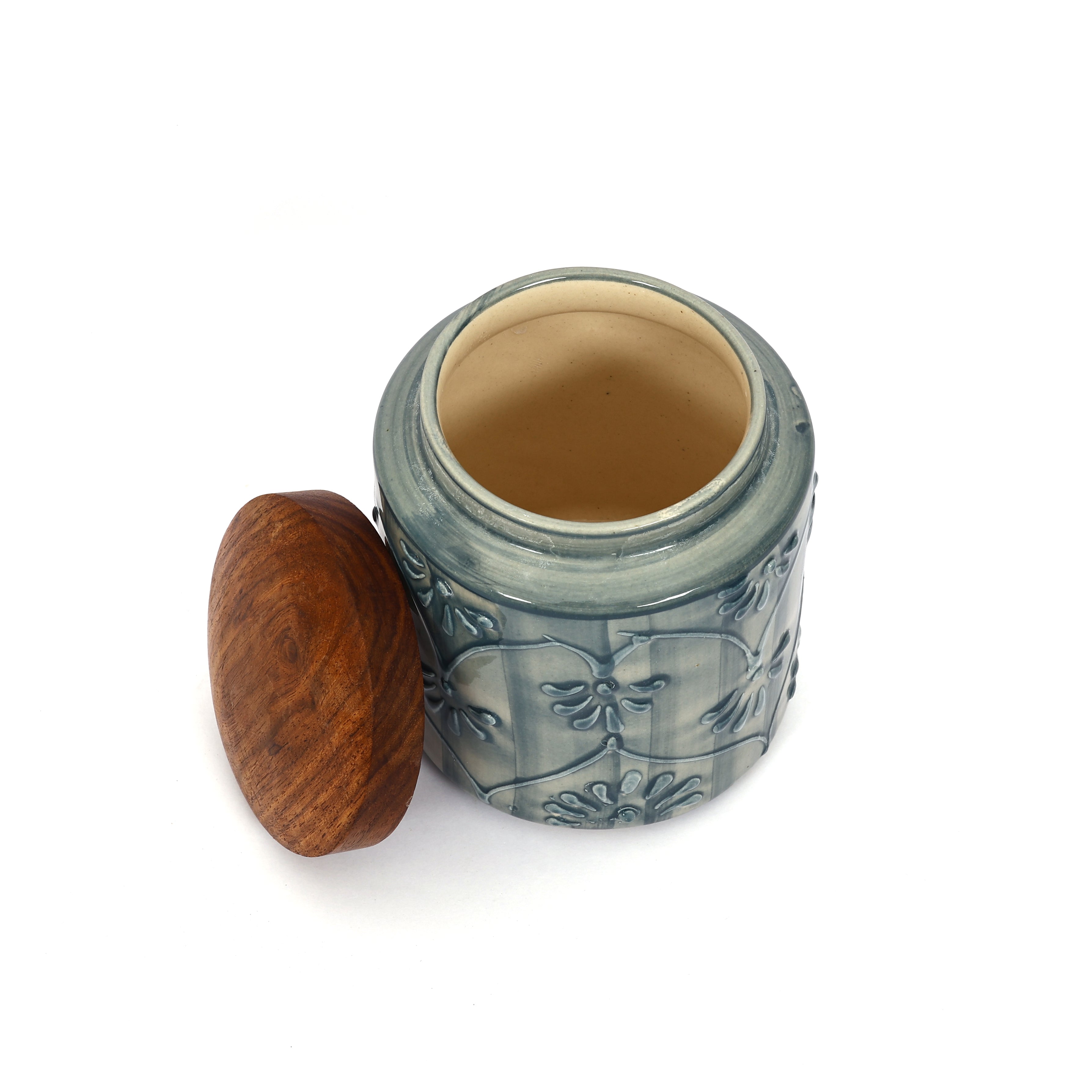 Ceramic jar with wooden lid on a white background