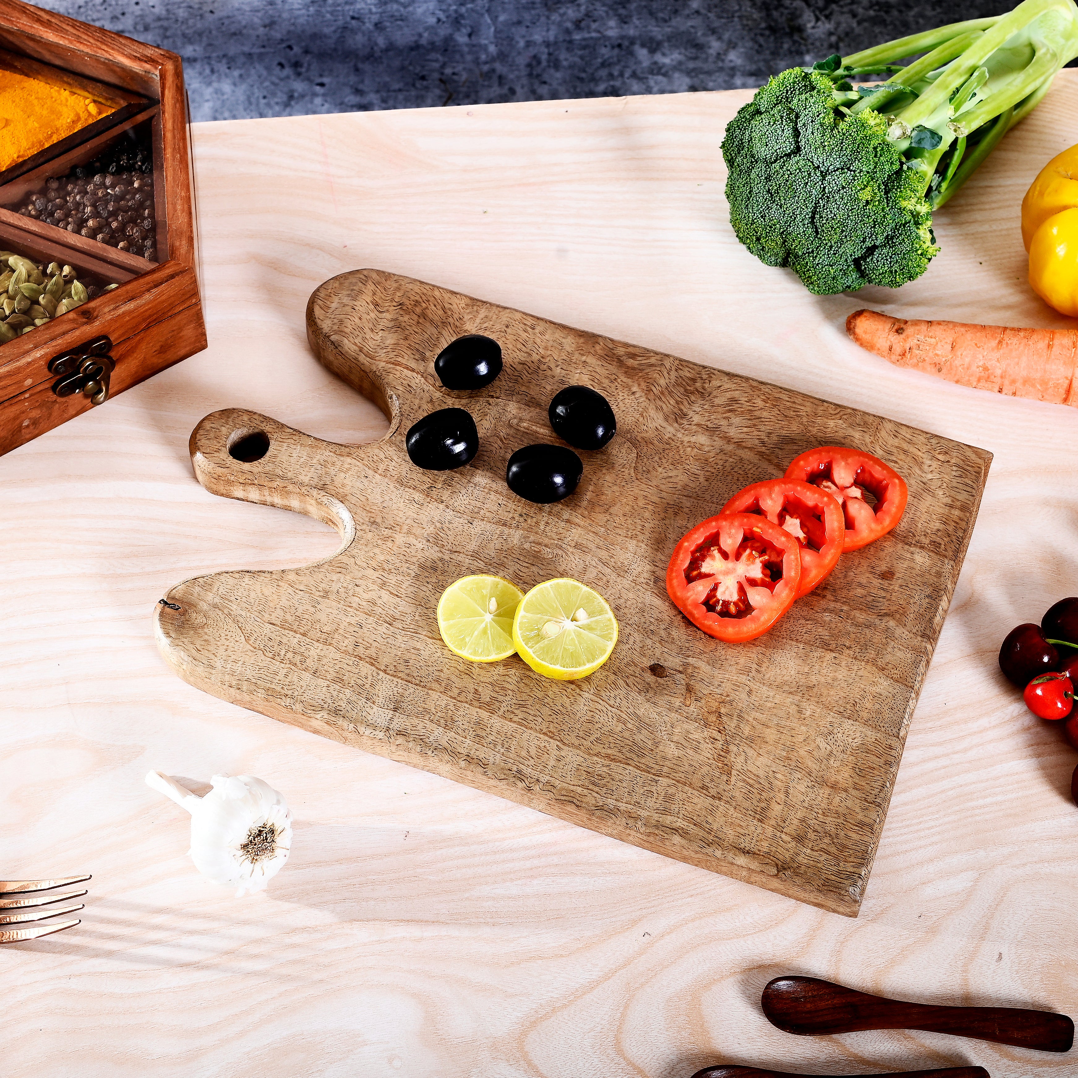 Wooden cutting board with sliced vegetables on a wooden table